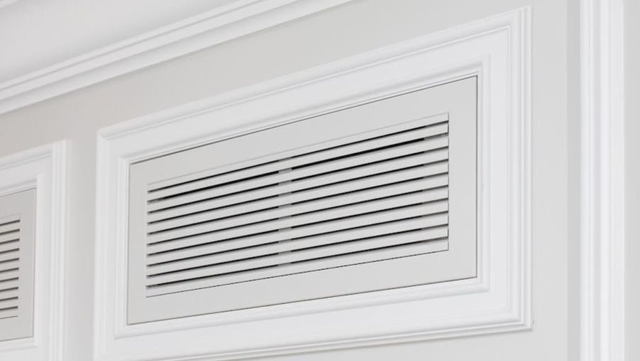 Vent in the wall covering an air filter.