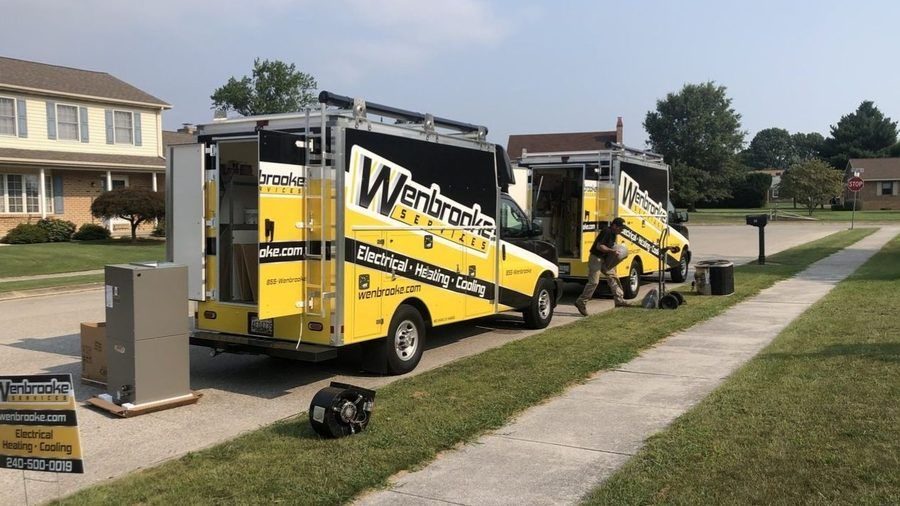 Wenbrooke electrical service trucks parked outside a residential home.