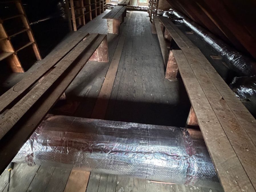 Air ducts in attic during an air duct sealing service.