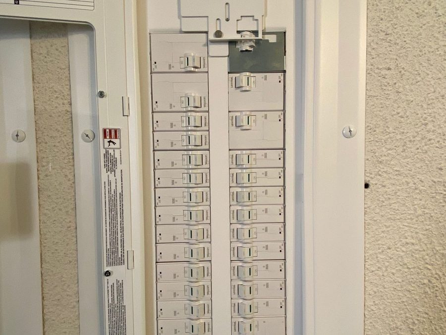 Electrical panel open on wall.