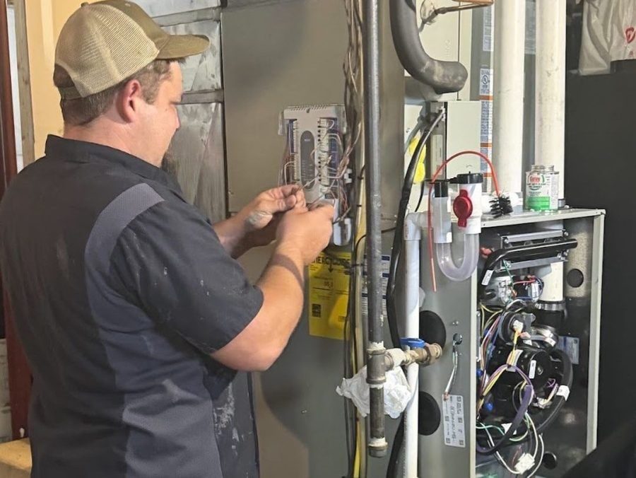 HVAC tech repairing furnace.